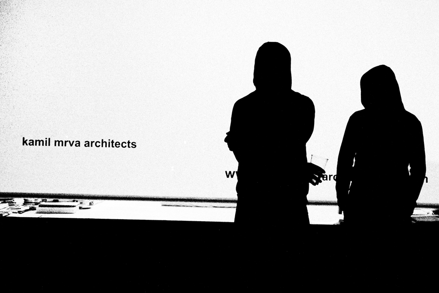 Black and white photo of two siluettes in front of Kamil Mrva Achitects atelier
